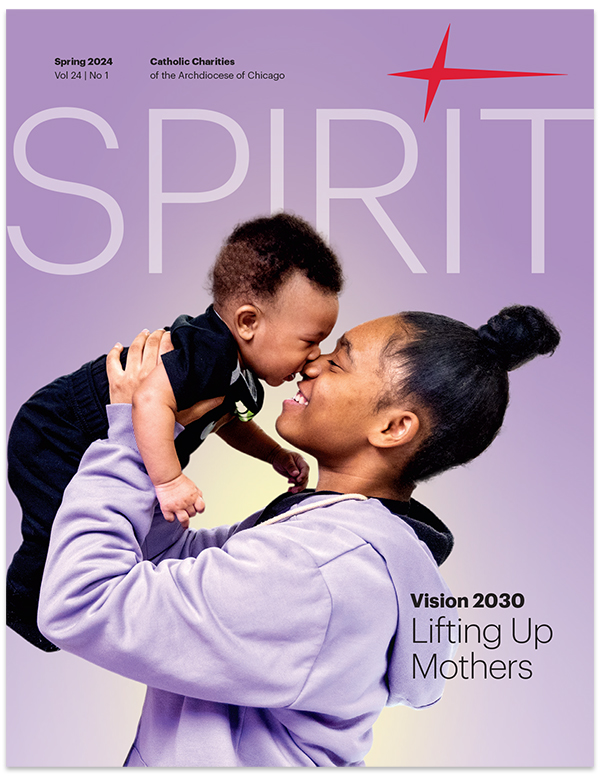 Spirit Magazine cover with person holding up baby to their face and smiling